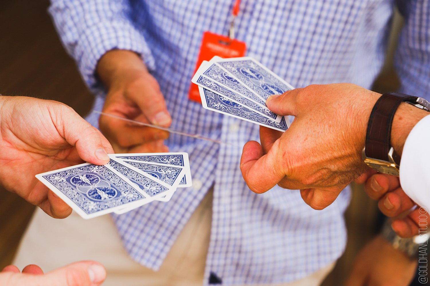 A blue-backed deck handled at close range beside an event badge