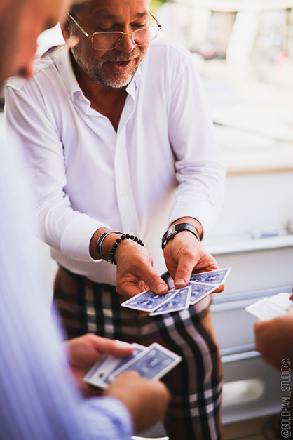 A deck being spread between two hands at a table