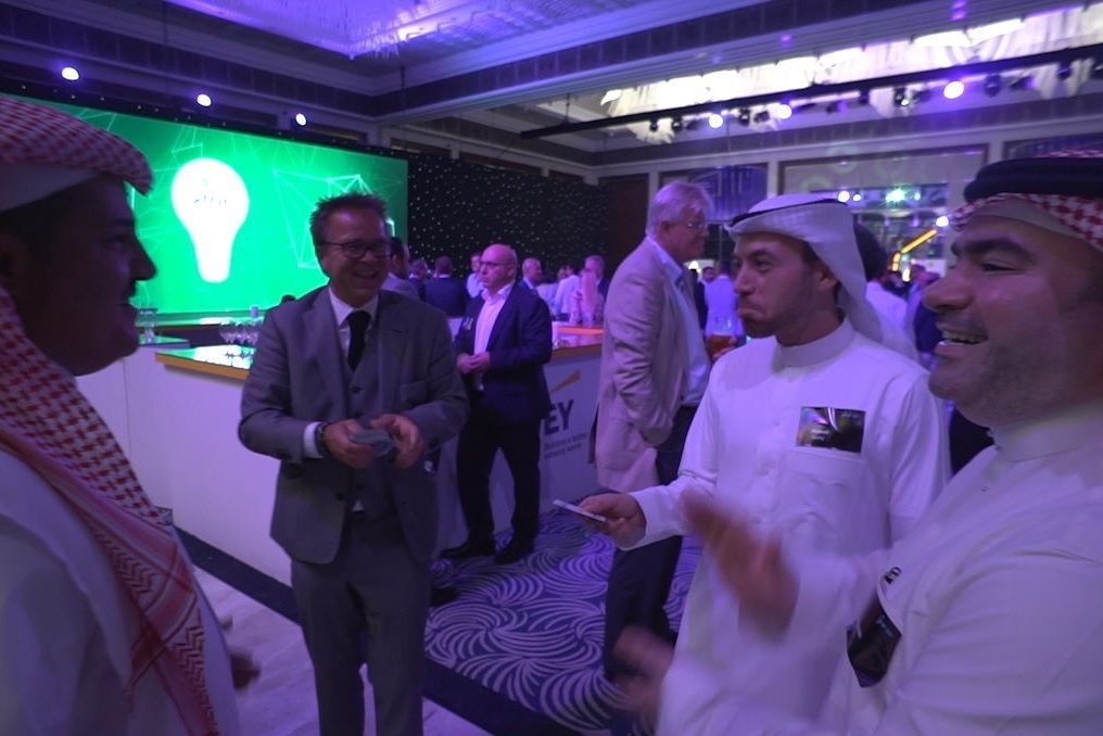 Guests at a reception in the Gulf watching close-up magic